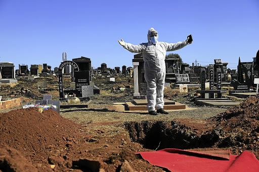 Reverend Didiza from Kagiso Methodist Church conducts the funeral of an 82-year-old woman who succumbed to Covid 19. / ALON SKUY