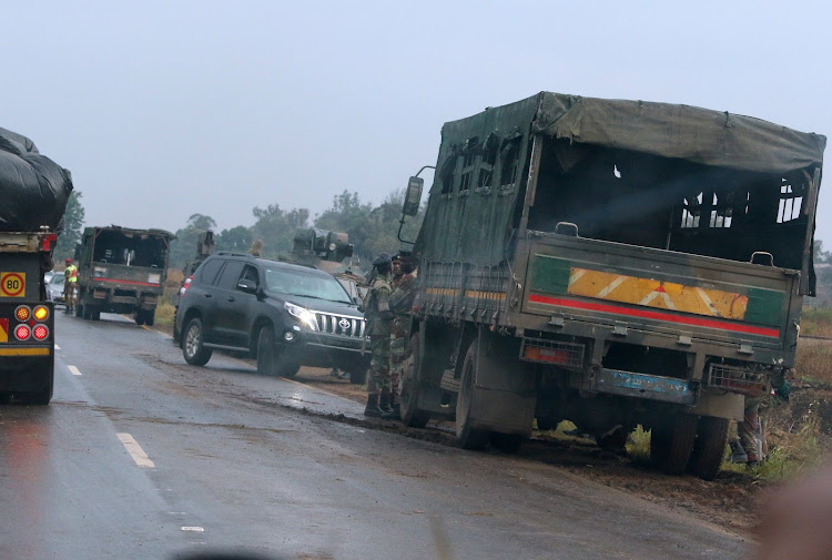 Soldiers stand beside military vehicles just outside Harare, Zimbabwe November 14,2017.