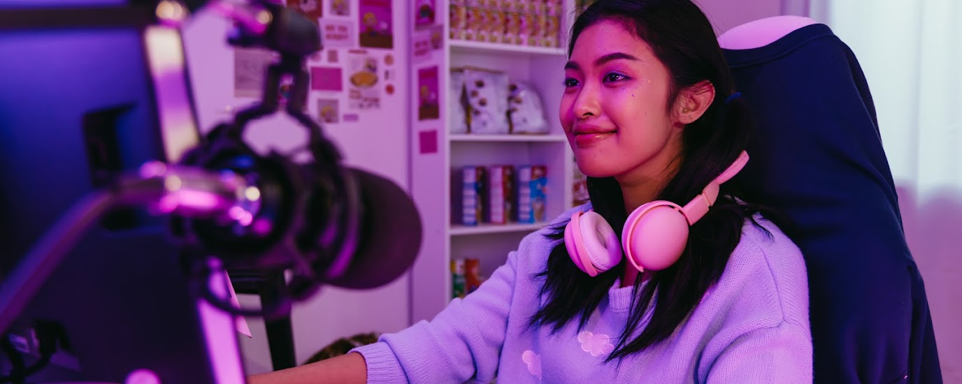 Girl playing games staring at computer monitor.