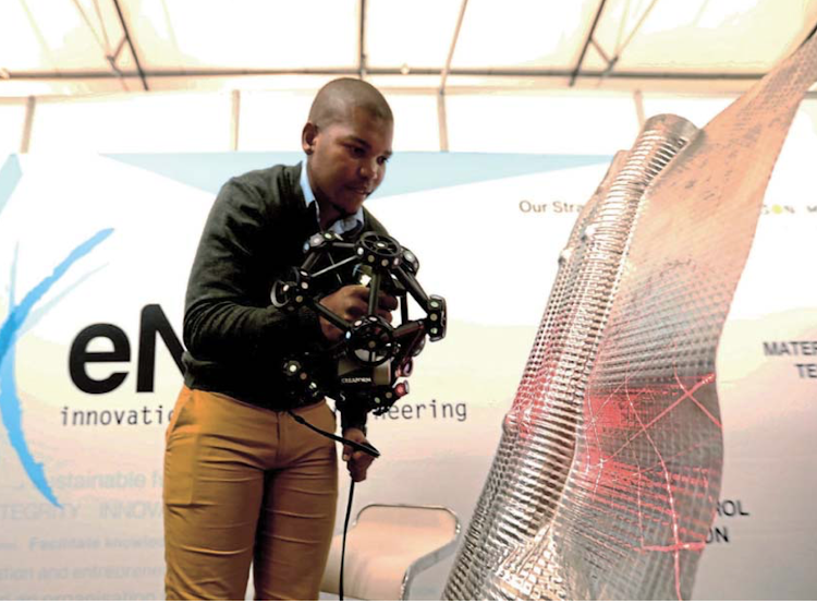 Andile Msimang from research and innovation hub eNtsa uses a 3D scanner at the African Advance Manu- facturing Show on Wednesday