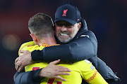 Liverpool manager Jurgen Klopp celebrates their victory over Southampton with Jordan Henderson after the Premier League match at St Mary's Stadium in Southampton on May 17 2022.