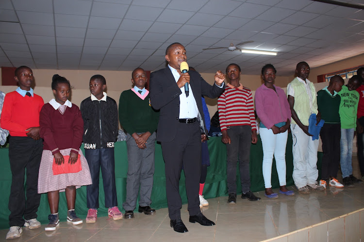 Kigumo MP Joseph Munyoro and some of the 35 students who will be fully sponsored using the NG-CDF kitty.