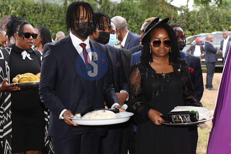 The late Paul Gicheru's wife Ruth Nyambura and her first born son Allan Njoroge Gicheru during the burial ceremony at Kwa-Nguku village in Bahati, Nakuru on October 6,2022.