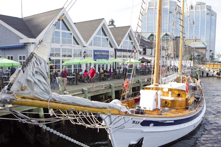  A schooner moored at the dock and pedestrian waterfront in Halifax, Nova Scotia. 