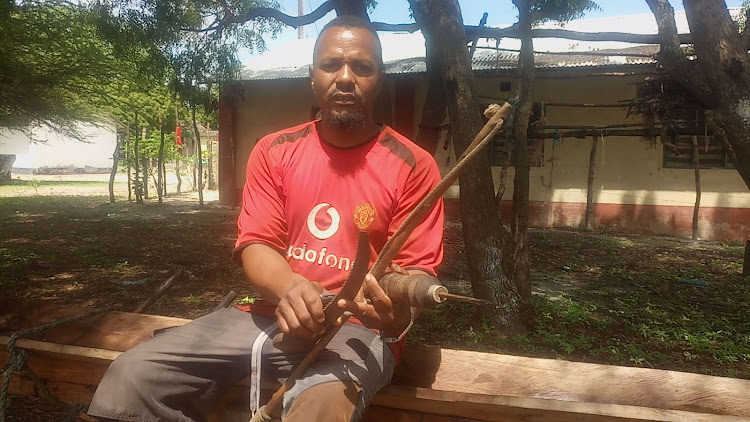 Lamu boat maker Ahmed Ali displays ancient boat making tools.