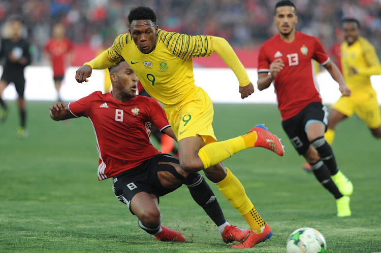 Lebogang Mothiba of South Africa vies with Sanad Ben Masaud of Libya during the 2019 AFCON qualifying match between Libya and South Africa at Stade Taieb Mhiri on March 24, 2019 in Sfax, Tunisia.