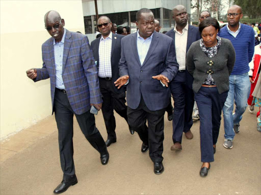 Education PS Bellio Kipsang, acting Interior Cabinet secretary Fred Matiangi and Moi girls secondary school principal Mrs. Jael Mureithi at the school following dawn fire that burnt the school Dormitory on September 1,2017. PHOTO/ENOS TECHE.