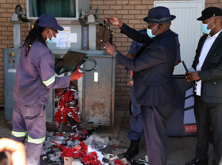 Police minister Bheki Cele and other law enforcement agencies destroy fake goods in Tembisa, Ekurhuleni on Saturday