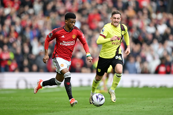 Manchester United attacker Amad Diallo runs with the ball under pressure from Jacob Bruun Larsen of Burnley during the Premier League at Old Trafford.