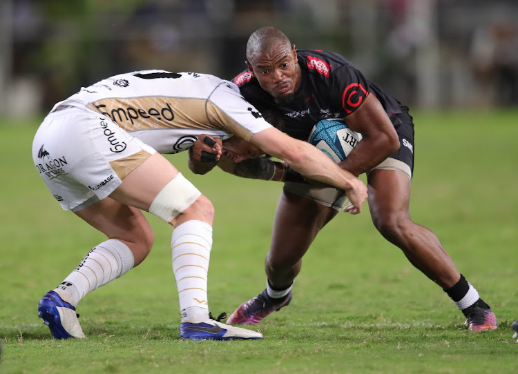 Sharks winger Makazole Mapimpi attempts to get past Josh Lewis of the Dragons tackle during their United Rugby Championship match at Kings Park in Durban.