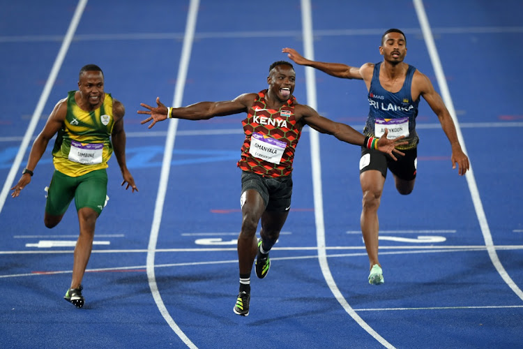 Ferdinand Omanyala of Kenya celebrates winning the 100m final ahead of Akani Simbine, left, and Yupun Abeykoon of Sri Lanka.