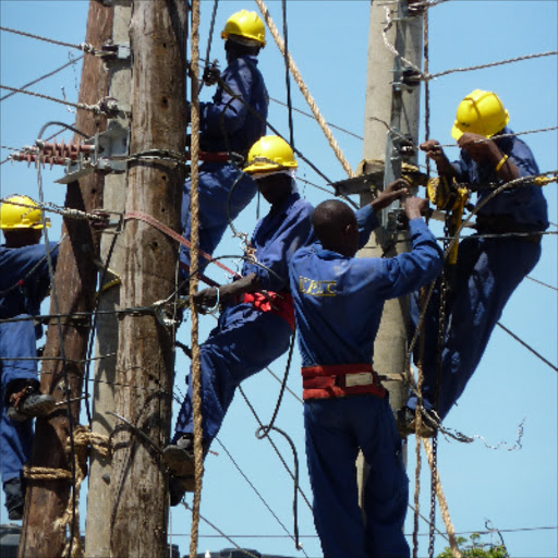 MEN AT WORK: KPLC staff connect power on Digo road in Mombasa.