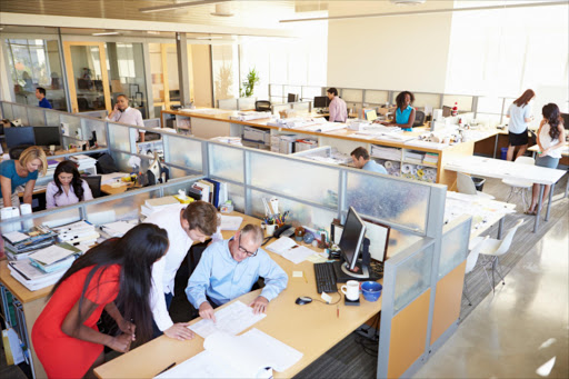 Open-plan offices are supposed to promote co-operation but most people just want to be left alone.