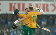 SA's David Miller celebrates his century with teammate Quinton de Kock in the second T20 international against India at Barsapara Cricket Stadium in Guwahati.