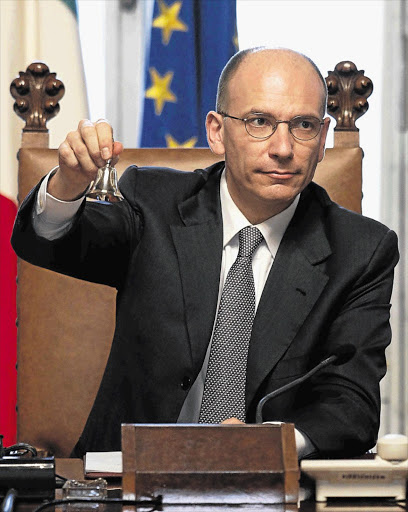 Newly appointed Italian Prime Minister Enrico Letta, above, was sworn in yesterday as an unemployed man shot and wounded two police officers in front of the Chigi Palace in Rome. Italy's economy remains hamstrung with deep political divisions