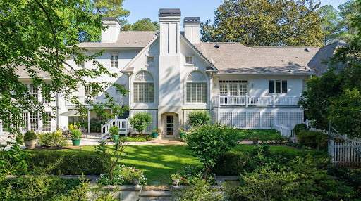 White house facade with tree-filled garden in this luxury house for sale in Atlanta ($2,649,000)