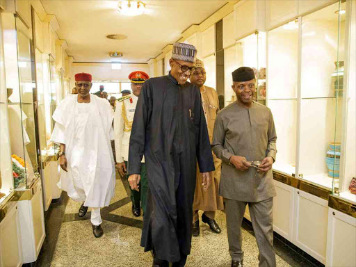 Nigeria's President Muhammadu Buhari, returning from a medical trip from London, is welcomed by Vice President Yemi Osinbajo in Abuja, Nigeria March 10, 2017. /REUTERS