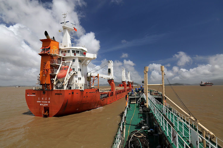 A Sinopec oil tanker approaches cargo vessel Dongtai Baoze, left, berthed at an anchorage off Zhoushan port to supply it with bunker fuel, in Zhejiang province, China. Picture: REUTERS/STRINGER