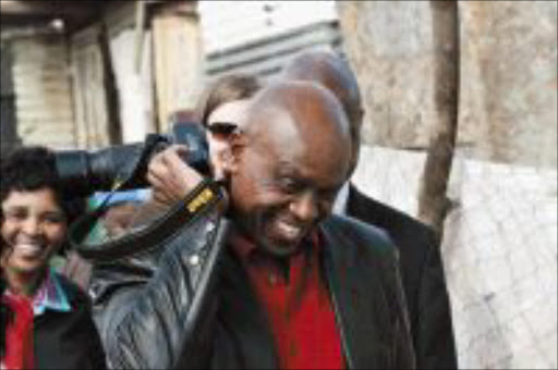 HARD AT WORK: Minister of Human Settlements Tokyo Sexwale takes a walk with journalists during his visit to Diepsloot yesterday. Pic: BAFANA MAHLANGU. 03/08/2009. © Sowetan.