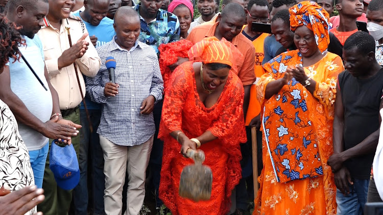 Deputy county comissioner Kigen Kefa, Ganze MP Teddy Mwambire look as Kilifi Woman Rep Getrude Mbeyu breaks the ground at Kauma Girls Secondary School