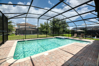 Large sun-drenched pool and spa deck at this Davenport vacation villa