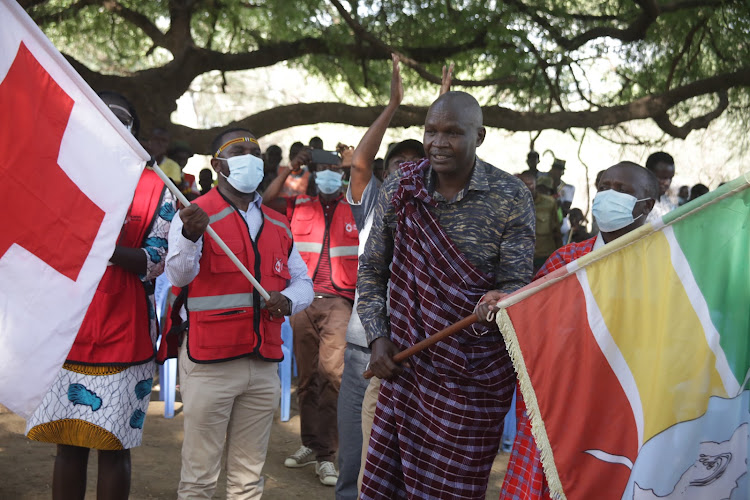 Kenya Red Cross disaster management coordinator Elijah Muli with Baringo Governor Stanley Kiptis during the launch of the cash transfer program at Nakoko, Tiaty subcounty on Wednesday.