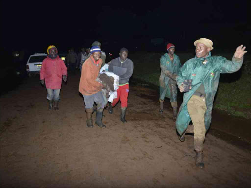 Residents assist people affected by the burst of Patel Dam in Subukia, Nakuru County, May 9, 2018. /RITA DAMARY