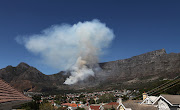 Smoke mushrooms from Table Mountain after a fire started around 12.30pm on Saturday. Image: Ruvan Boshoff