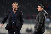 The Crusaders coach Scott Robertson (L) with his Hurricanes counterpart Jason Holland (R) just before their round seven Super Rugby Aotearoa match at Orangetheory Stadium in Christchruch on July 25, 2020.