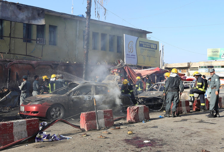 Afghan policemen inspect the site of a blast in Jalalabad city, Afghanistan, July 1, 2018.