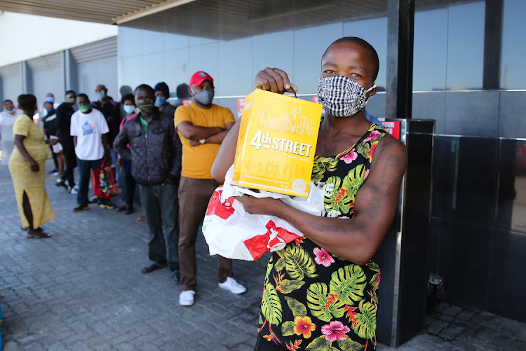 Patrons eager to quench their thirst after more than two dry months during lockdown levels 4 and 5 queue at Tops in New Brighton. Myali Yatani is happy with his purchase