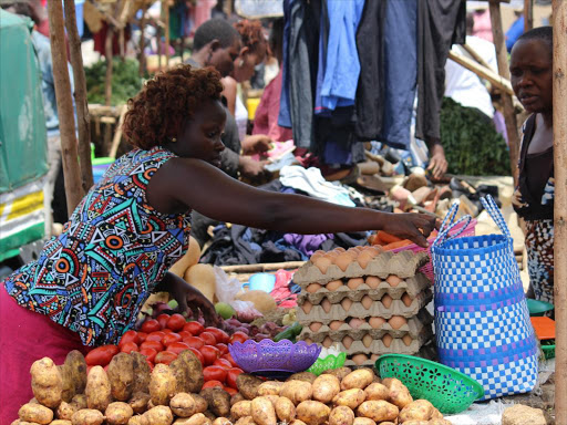 A woman sells vegetables in Kondele, Kisumu town/FILE