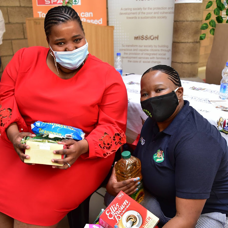 Social development MEC Siphokazi Lusithi hands over a donation to the Likusasa Lomama community organisation’s Pumla Boya Dyafta