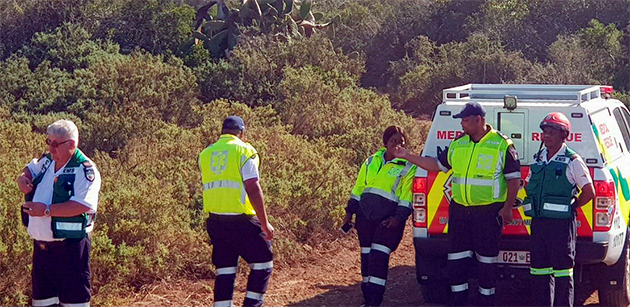 Rescue personnel attend the scene after the plane accident. Both the pilot and his passenger were unharmed