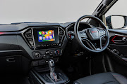 Leather steering features red contrast stitching. A seven-inch infotainment screen syncs with Apple CarPlay and Android Auto.