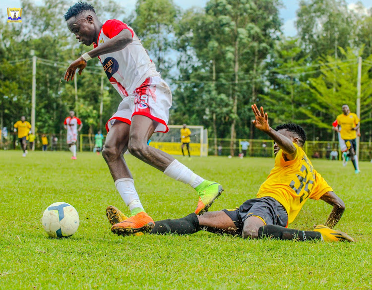 Kakamega Homeboyz' Hillary Otieno in action with Muhoroni Youth's Kelvin Wesonga during a KPL match at Muhoroni Stadium