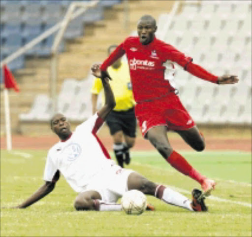 20091223AMU/SPORTS/SOCCER. Free State Stars Ayanda Gcaba drebble past Moroka Swallows Lungisani Ndlela during their ABSA/.PSL match at Dobsonville Stadium in Soweto. PHOTO: ANTONIO MUCHAVE