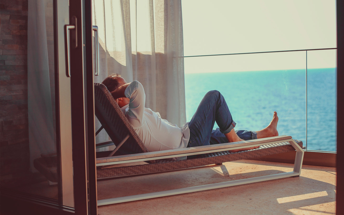 woman relaxing in terrace looking at sea