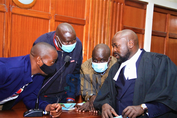 Three of the five accused Leonard Mwangi, Stephen Cheburet and Fredrick Leliman with their lawyer Cliff Ombeta at Milimani law courts on September 6, 2021.