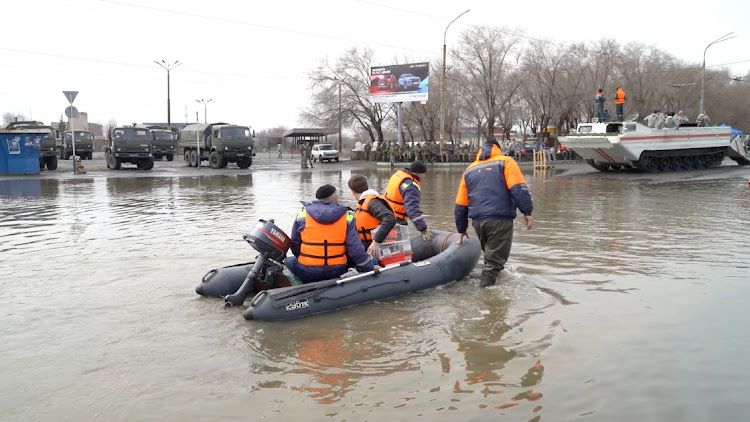 Rescuers ride a boat in a flooded street of Orsk, Russia, April 9 2024, in this still image taken from video. Picture: REUTERS TV/REUTERS