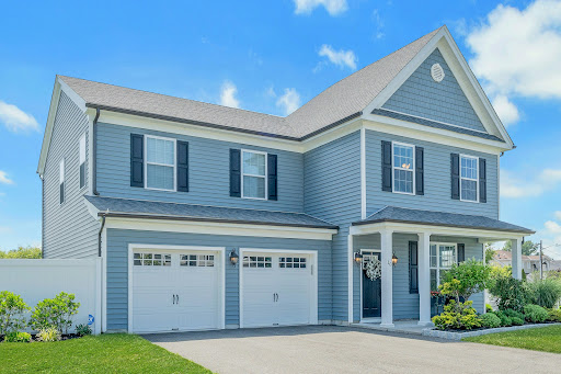 Blue house with two white garages in this luxury house for sale in Little Ferry ($999,000)