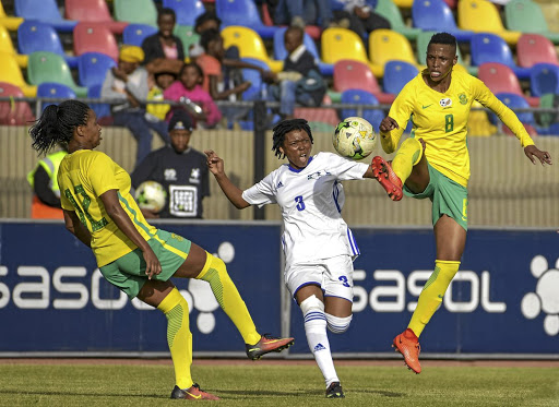 Jermaine Seoposenwe of Banyana, left, gets her foot in as teammate Kgaelebane Mohlakoana, right, towers above Tsoanelo Leboka of Lesotho during their qualifier yesterday.