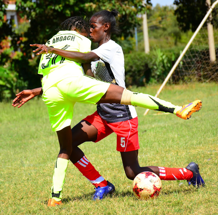 Pauline Akinyi of Kibera vies for the ball with Gaspo's Sheryl Angachi in a past WPL duel.