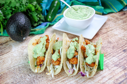 Avocado Crema drizzled over tacos.