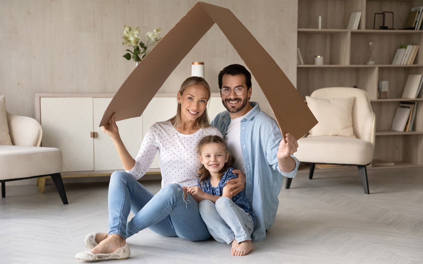 happy family with daughter sitting in living room