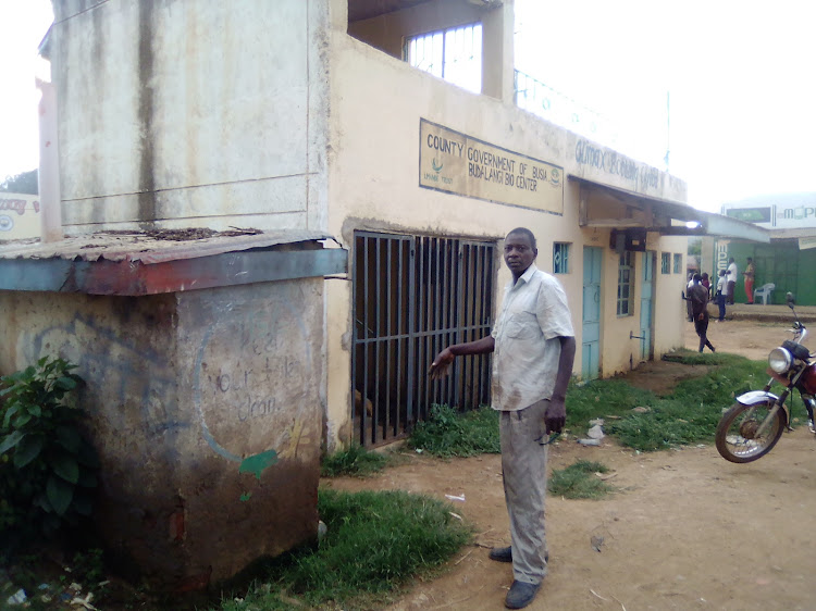 Former market chairman Albert Okuku next to the closed public toilet at the Sh2.7 million bio-centre at Budalangi trading centre in Busia.