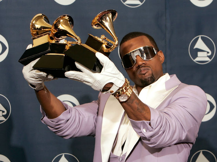 Singer Kanye West poses with his Best Rap Song, Best Rap Solo Performance and Best Rap Album at the 48th Annual Grammy Awards in 2006.