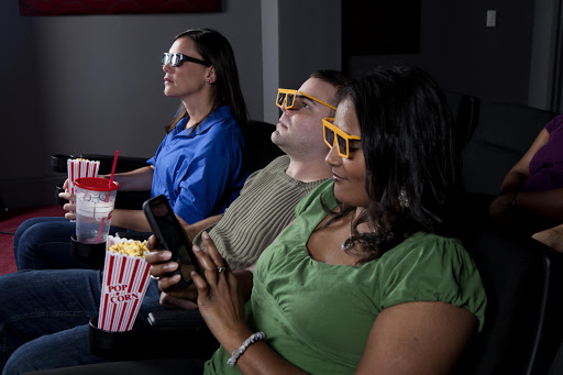 File photo. A Texas man got so ticked off when his date refused to stop texting during a movie‚ he is suing her for the price of the movie ticket.