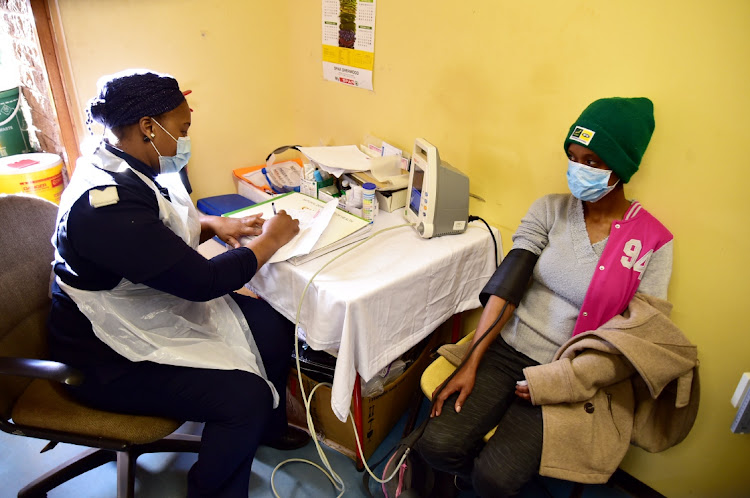 Sister Thelma Sishuba attends to Greshem Lewies, 26, in a corridor used as an observation area at the Malabar Clinic because of a chronic space shortage. The overcrowding was brought to light during an oversight visit led by DA provincial leader Nqaba Bhanga.