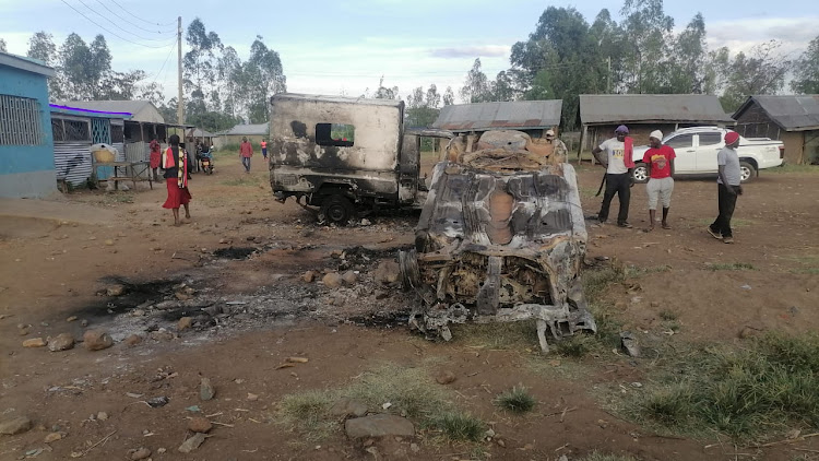 Torched police vehicles at Nyakungru market in Muhoroni, Kisumu